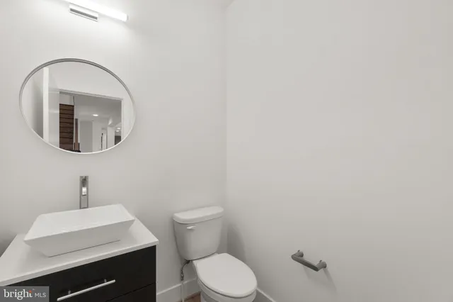 a view of a livingroom with wooden floor and staircase