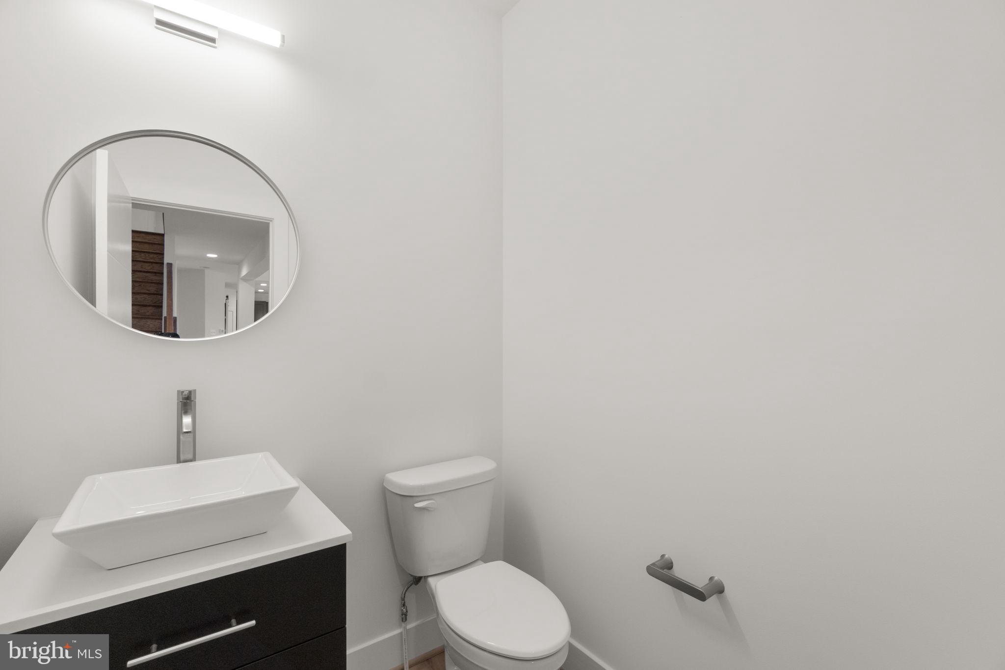14628 Old Hanover Road, Unit BENTON Reisterstown, MD 21136 - Photo 26 of 69 a bathroom with a toilet a sink and mirror