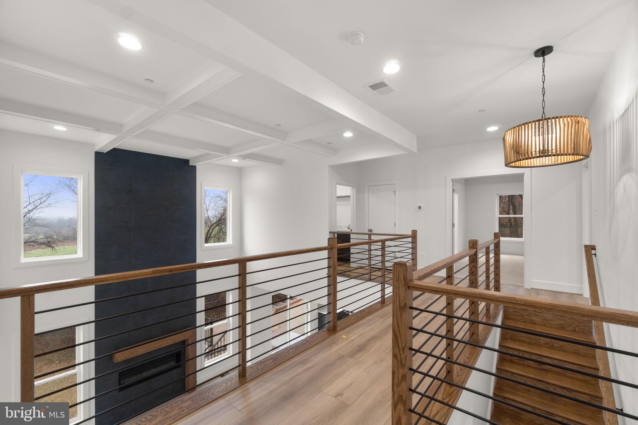 14628 Old Hanover Road, Unit BENTON Reisterstown, MD 21136 - Photo 28 of 69 a view of a hallway with couches and chandelier