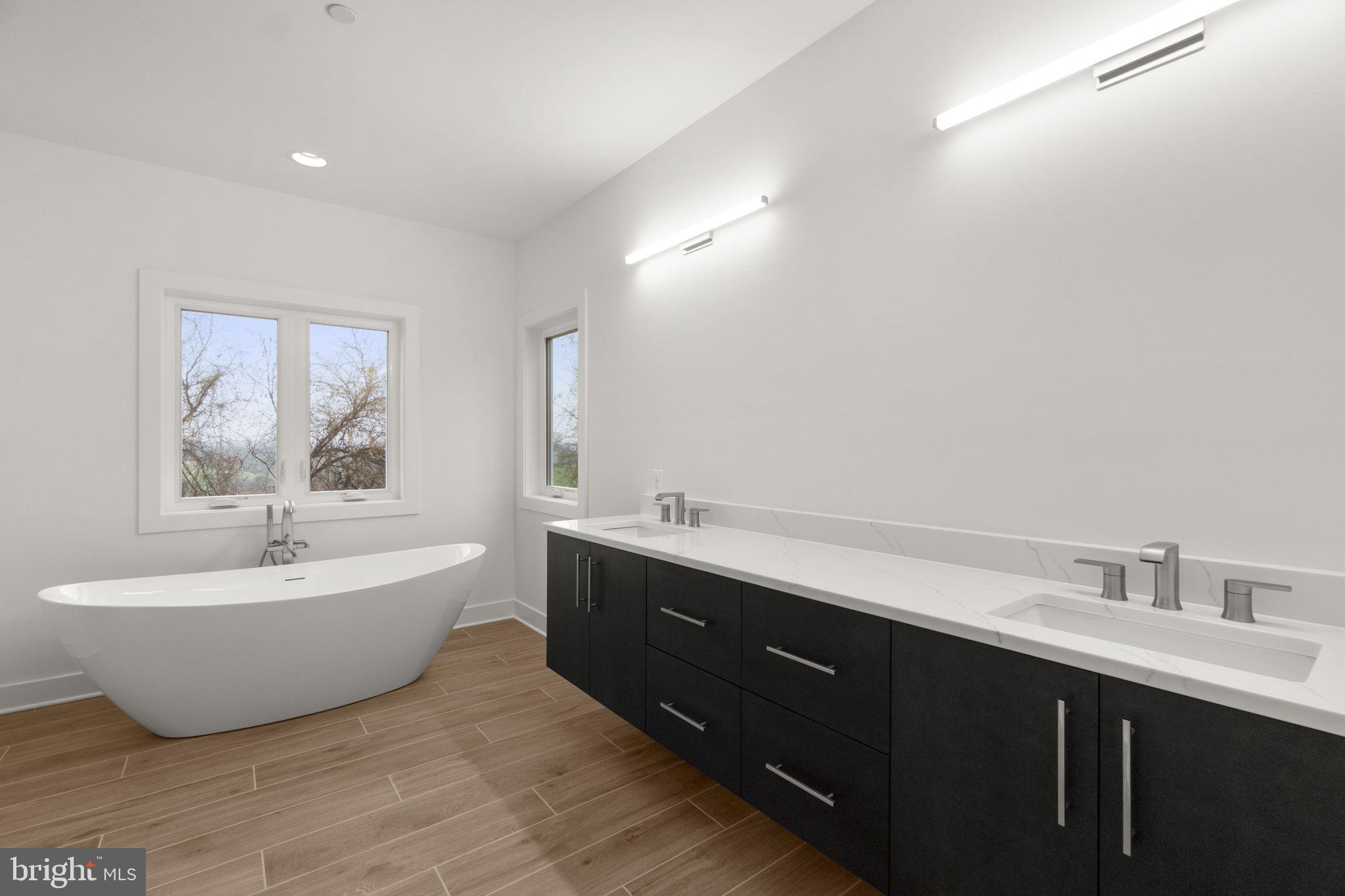14628 Old Hanover Road, Unit BENTON Reisterstown, MD 21136 - Photo 35 of 69 a spacious bathroom with a double vanity sink mirror and bathtub