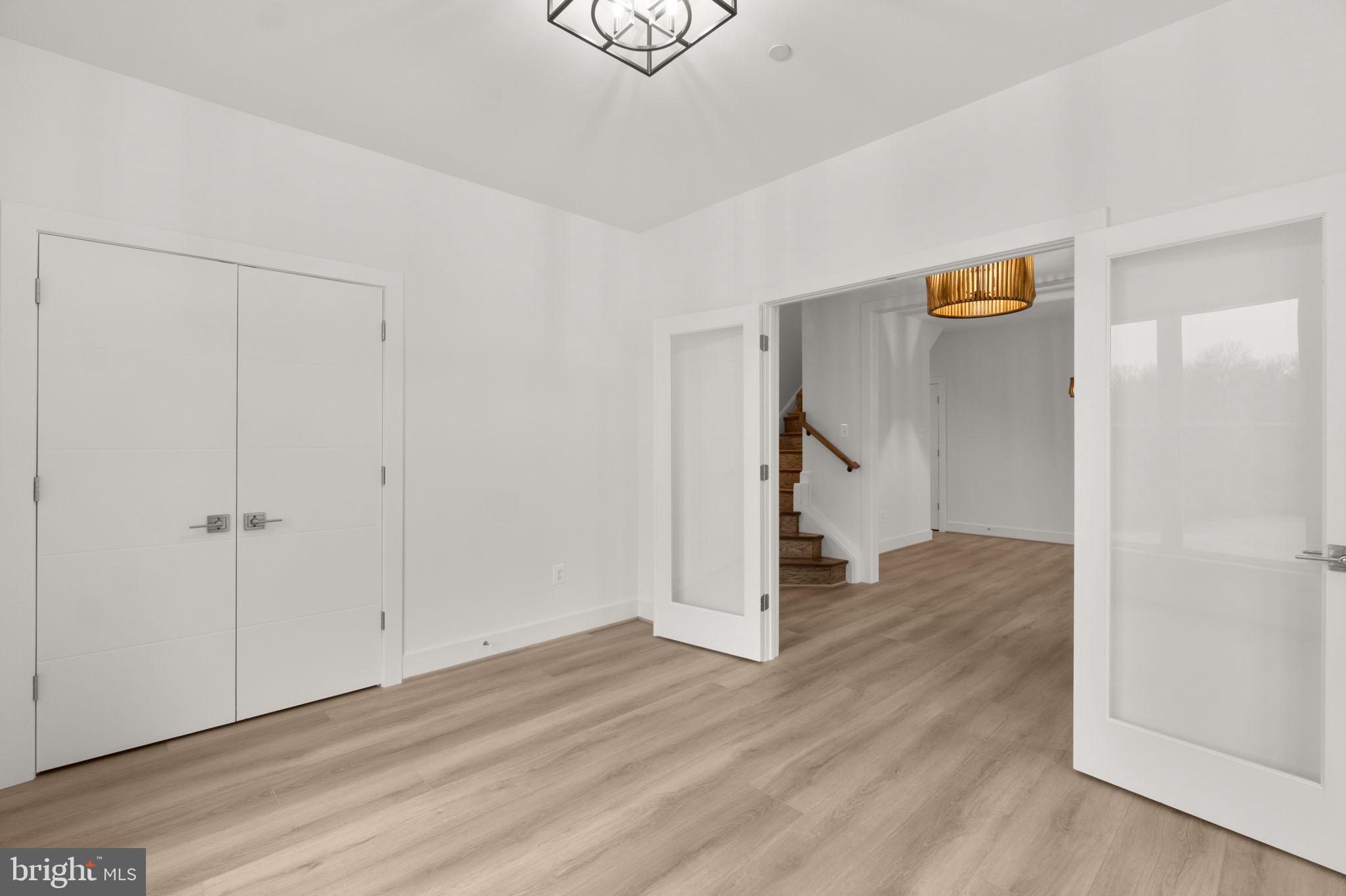 14628 Old Hanover Road, Unit BENTON Reisterstown, MD 21136 - Photo 5 of 69 a view of an empty room with wooden floor and entryway