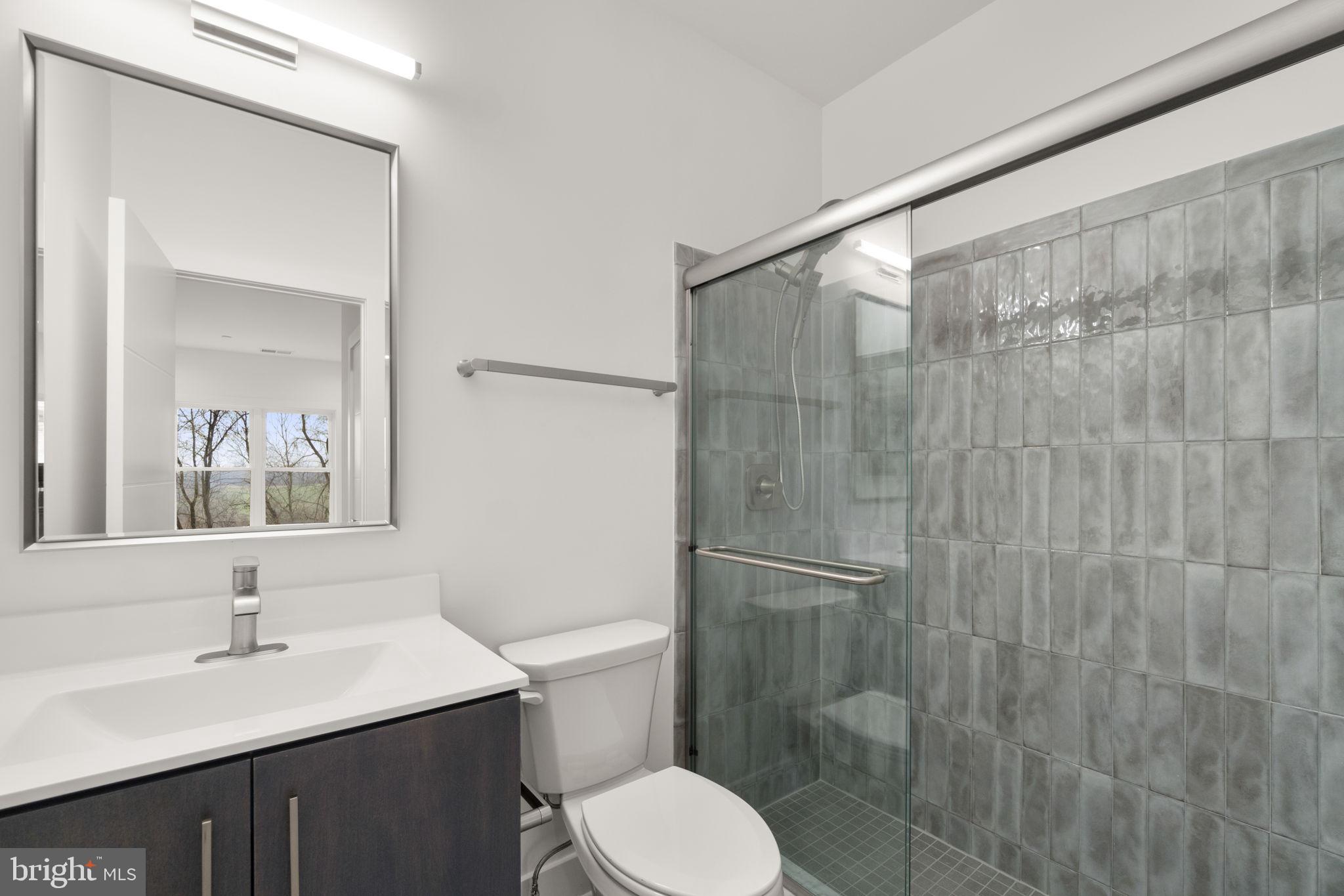 14628 Old Hanover Road, Unit BENTON Reisterstown, MD 21136 - Photo 52 of 69 a bathroom with a sink toilet and shower