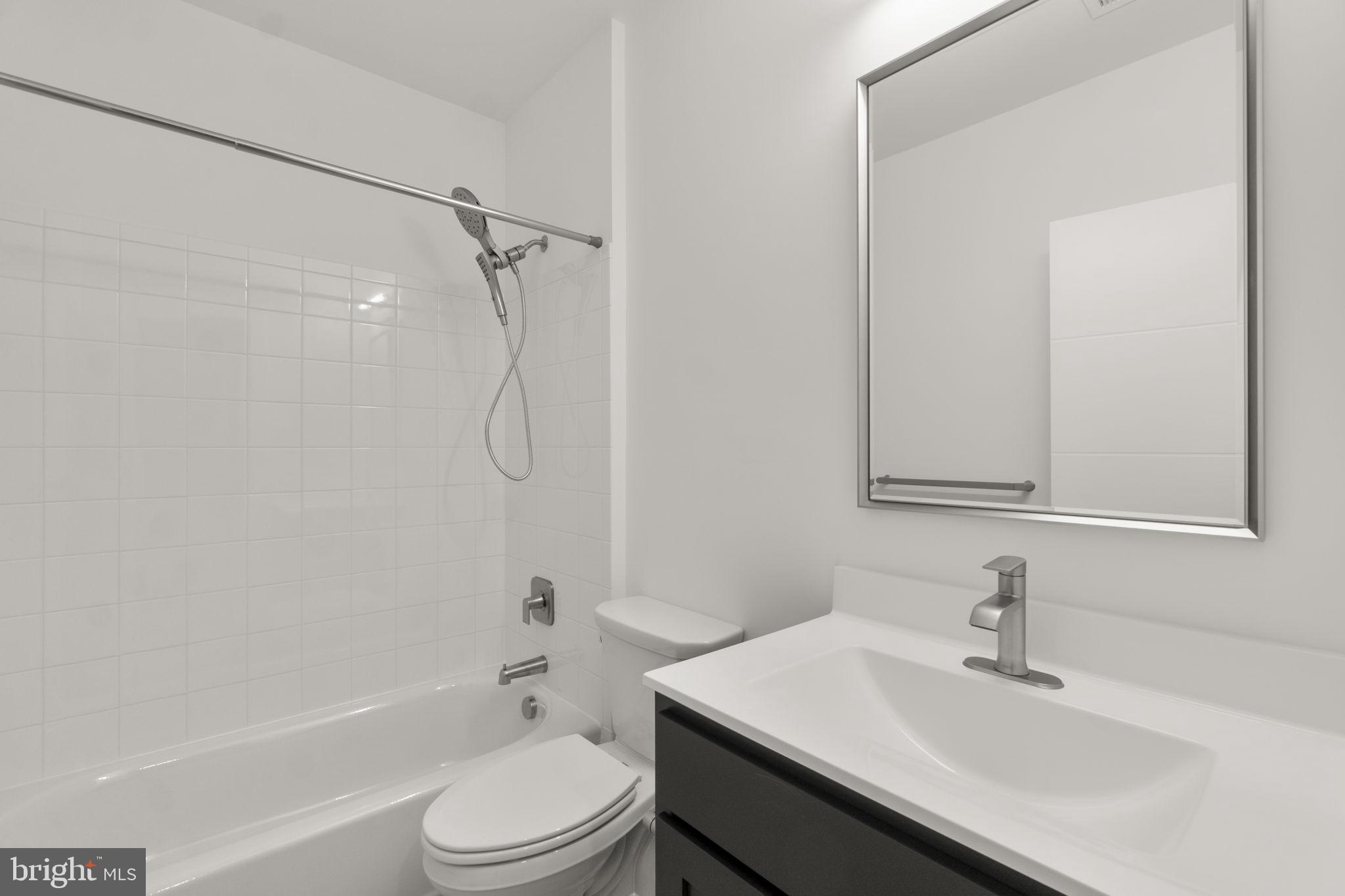 14628 Old Hanover Road, Unit BENTON Reisterstown, MD 21136 - Photo 59 of 69 a bathroom with a sink toilet vanity and shower