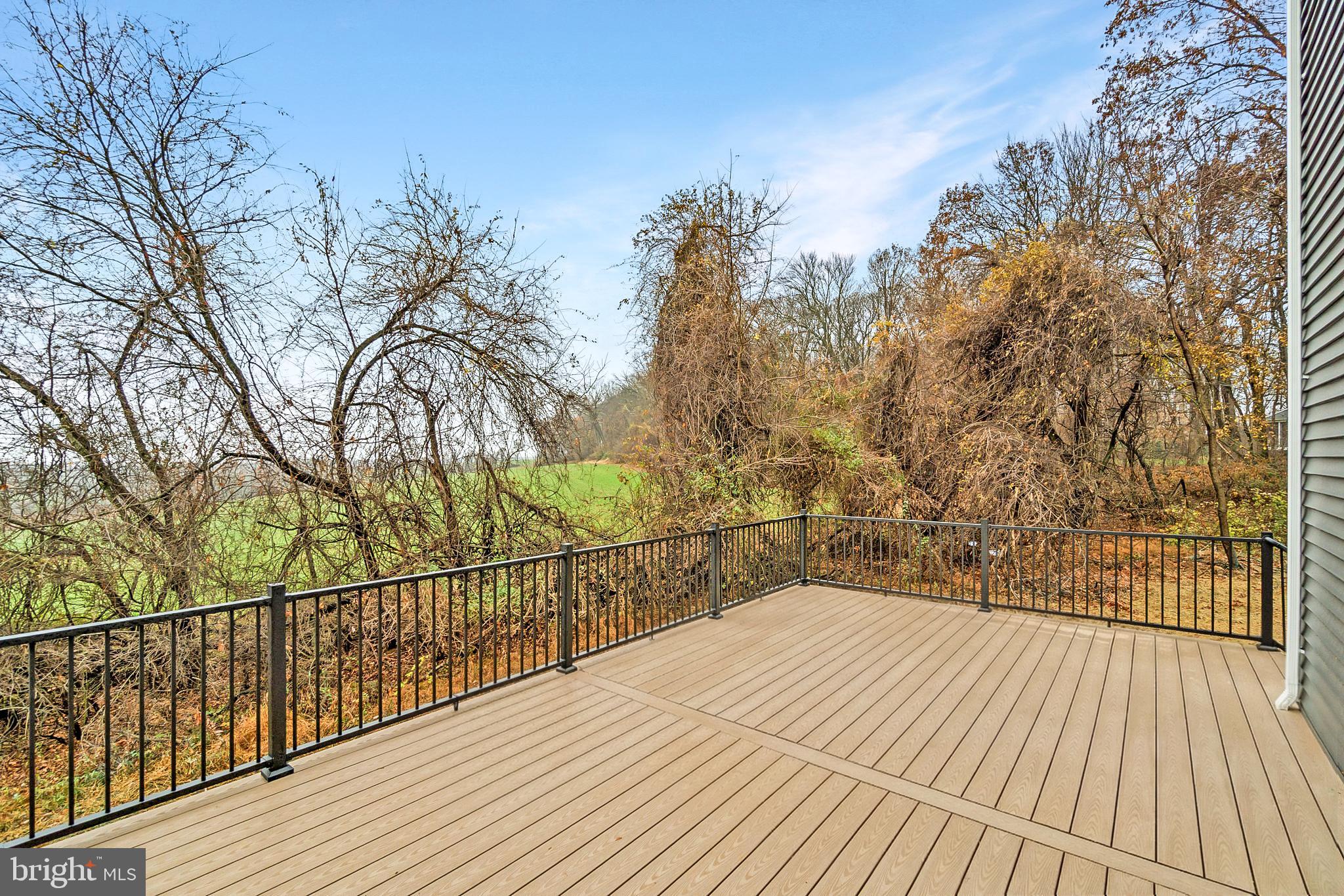 14628 Old Hanover Road, Unit BENTON Reisterstown, MD 21136 - Photo 61 of 69 a view of a balcony with wooden floor and fence