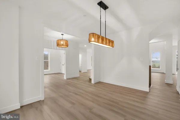 a view of an empty room and wooden floor