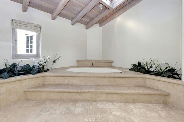 a spacious bathroom with a tub a sink and mirror
