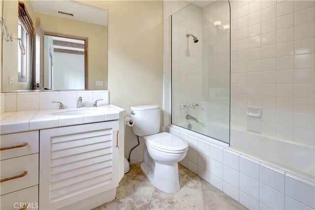 a bathroom with a sink vanity and mirror