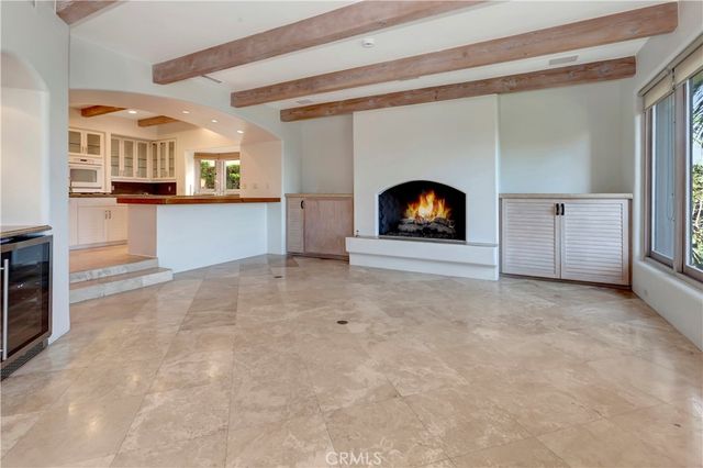 a view of a livingroom with a fireplace and a window