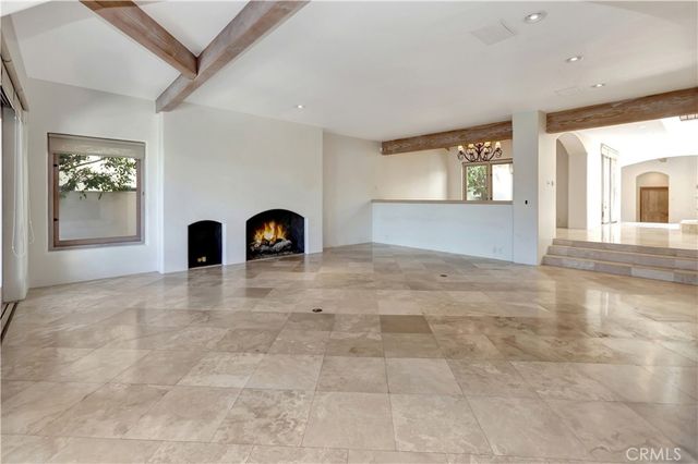 a view of a livingroom with wooden floor and a fireplace