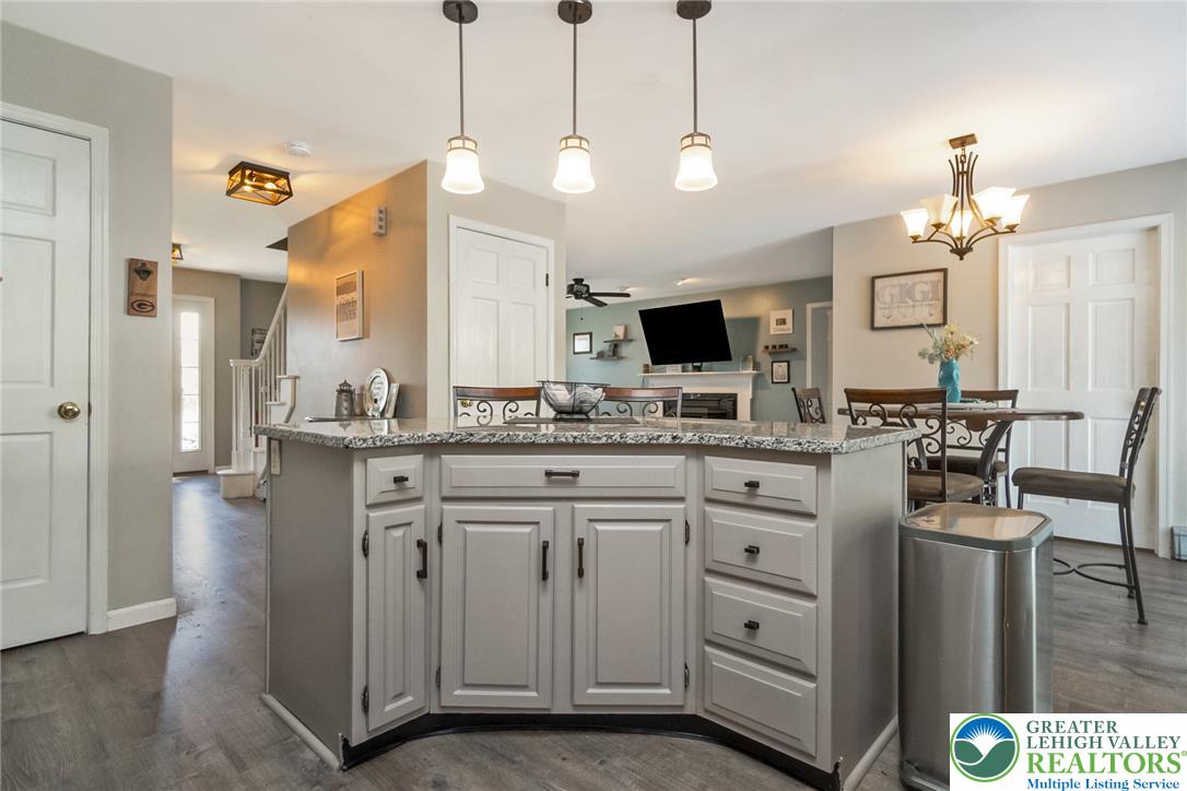 9461 Red Road Kempton, PA 19529 - Photo 10 of 55 A centrally located kitchen island with granite counters defines this versatile open-concept living space.