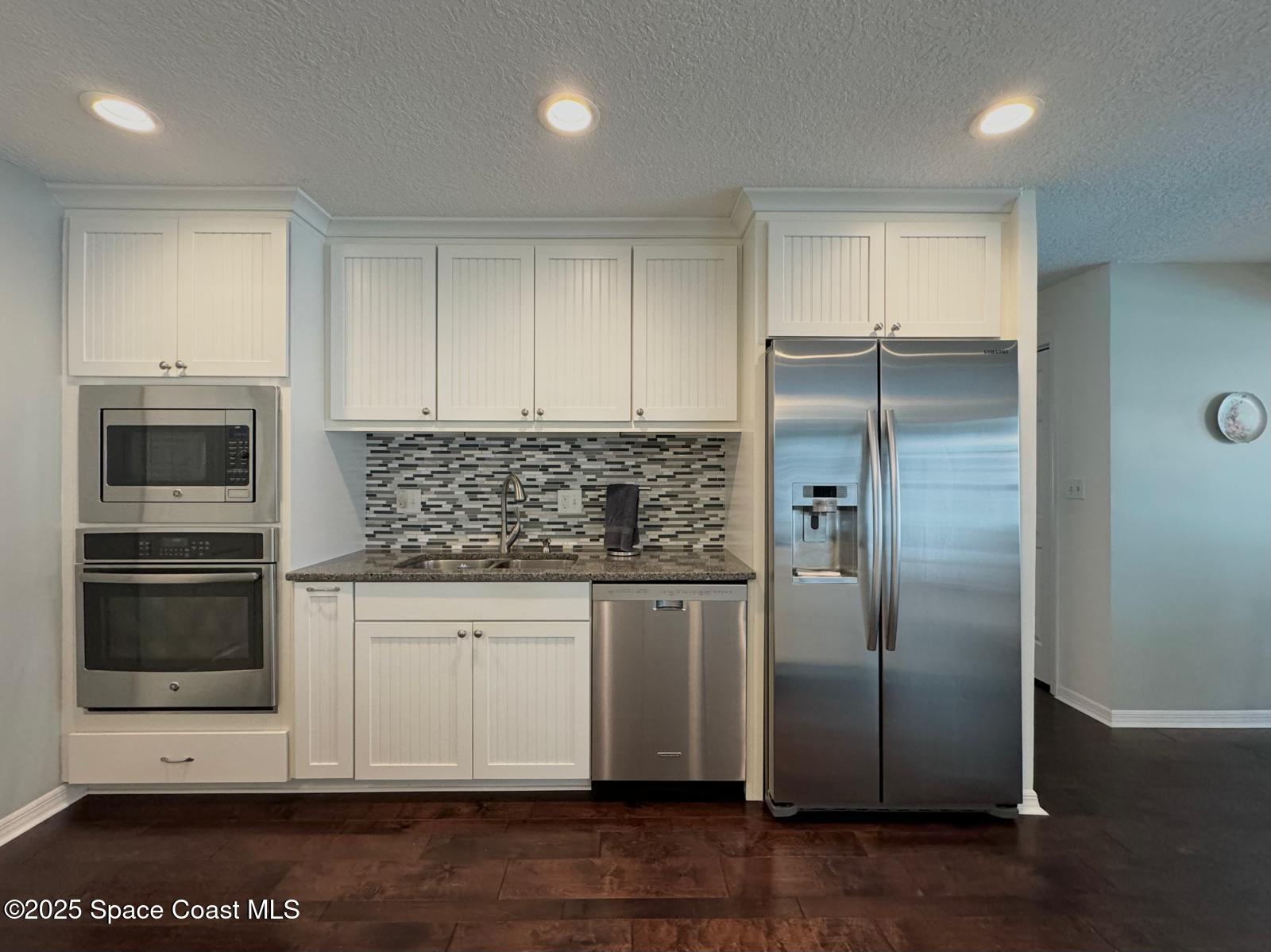 420 Rio Casa Drive North Indialantic, FL 32903 - Photo 17 of 49 a kitchen with stainless steel appliances granite countertop a refrigerator and a stove top oven