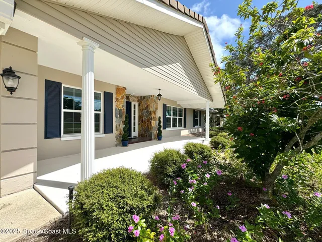 a view of a house with potted plants