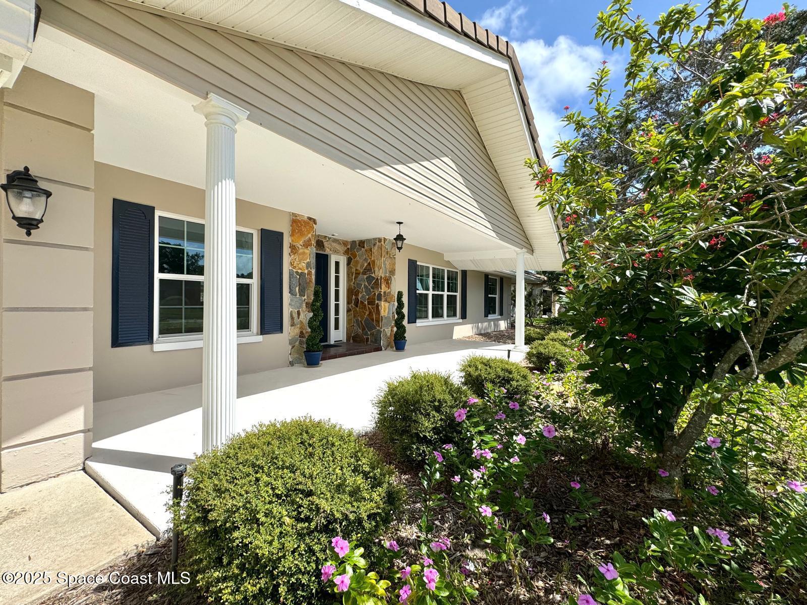 420 Rio Casa Drive North Indialantic, FL 32903 - Photo 2 of 49 a view of a house with potted plants