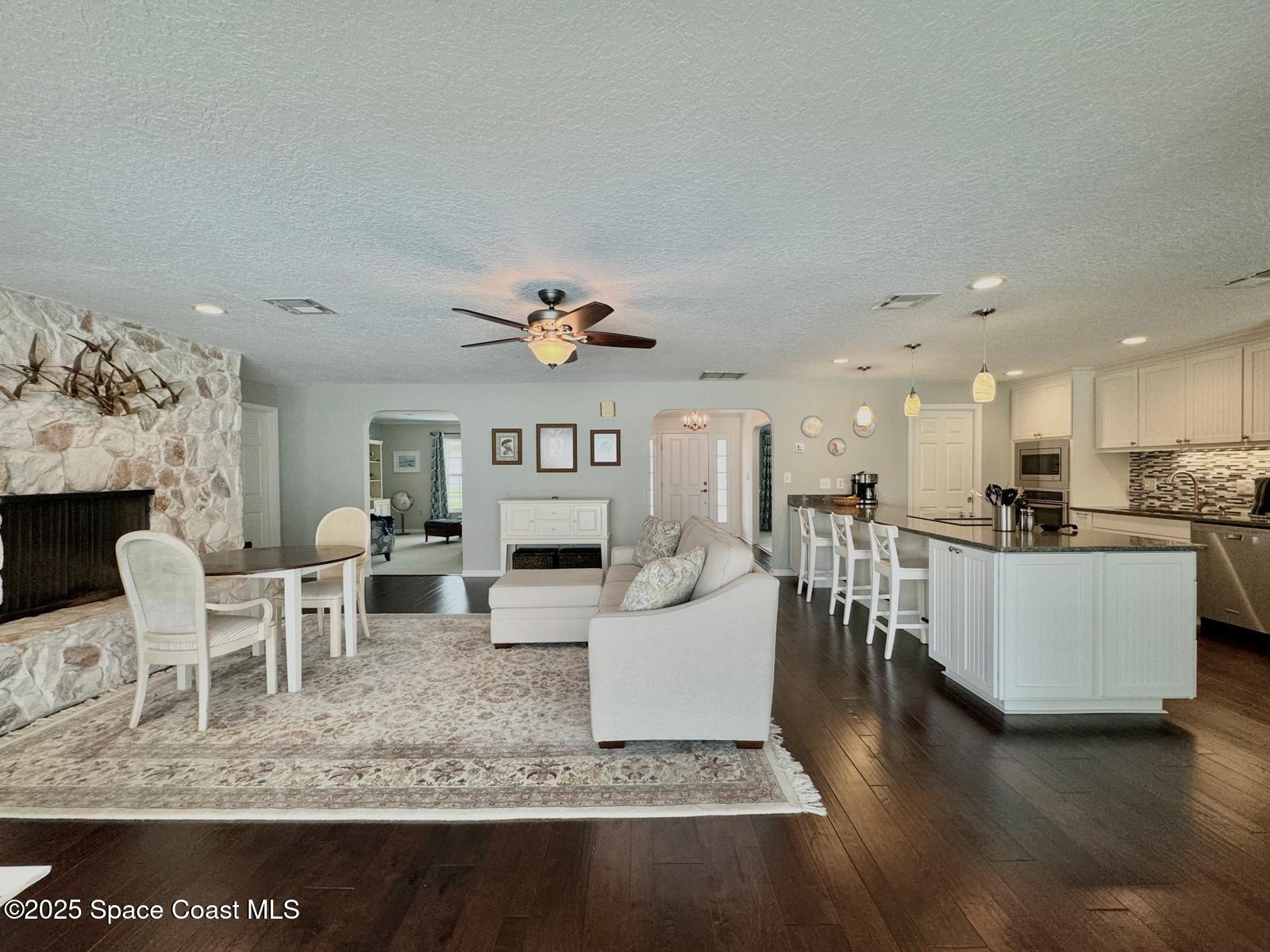 420 Rio Casa Drive North Indialantic, FL 32903 - Photo 21 of 49 a living room with furniture a wooden floor and kitchen view