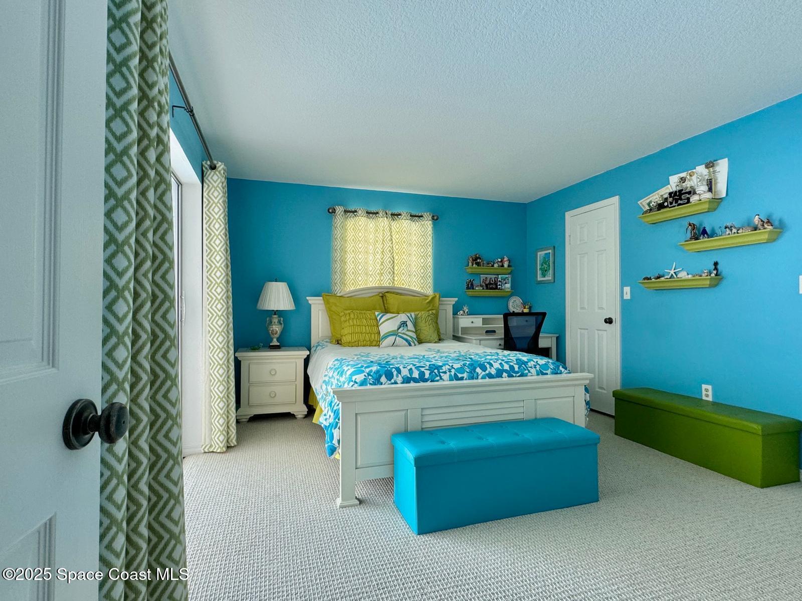 420 Rio Casa Drive North Indialantic, FL 32903 - Photo 25 of 49 a bedroom with a bed and a chandelier