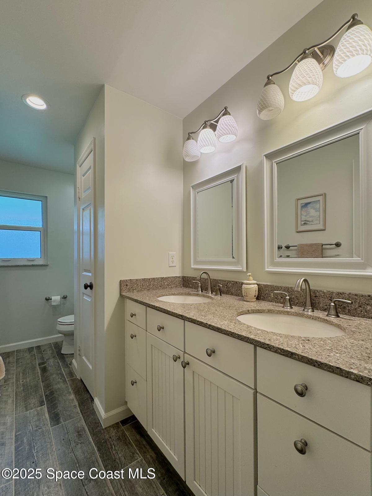 420 Rio Casa Drive North Indialantic, FL 32903 - Photo 26 of 49 a bathroom with a granite countertop sink and a mirror