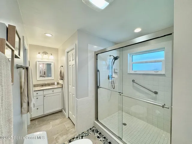 a bathroom with a shower and a sink