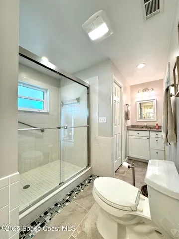 a bathroom with a toilet sink and shower