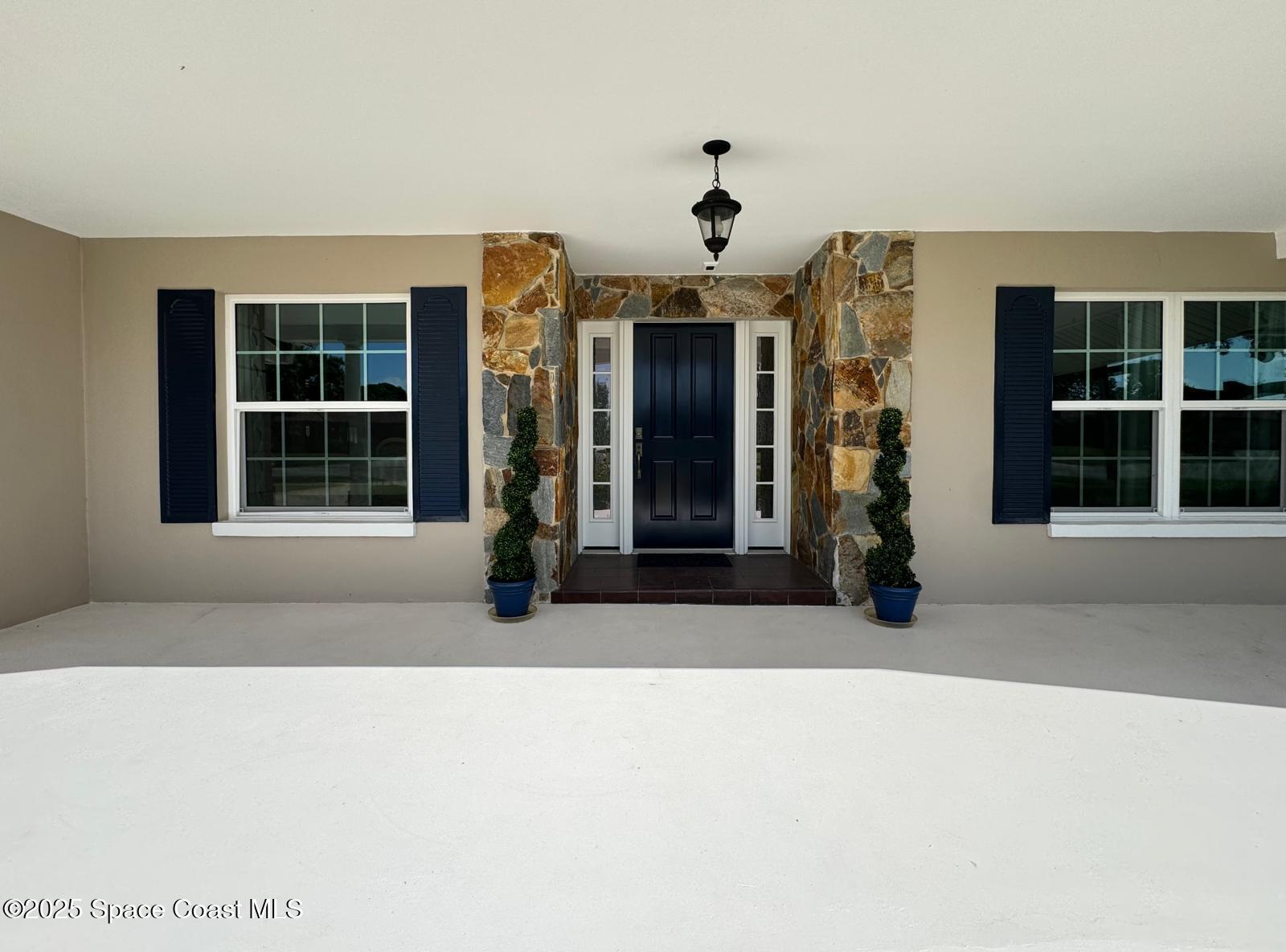 420 Rio Casa Drive North Indialantic, FL 32903 - Photo 5 of 49 a living room with a large window and a refrigerator