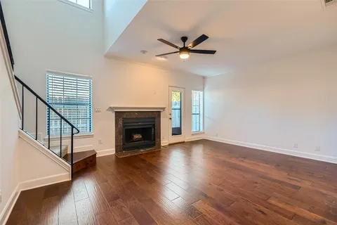 a view of a hallway with furniture and wooden floor