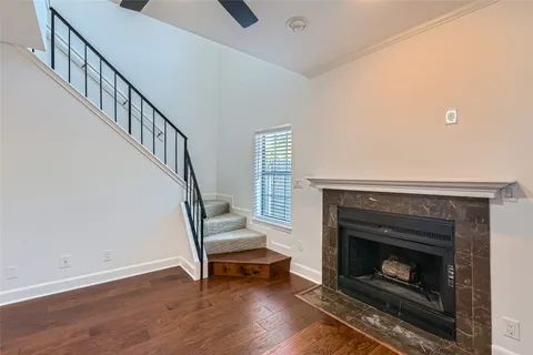 a view of empty room with fireplace and wooden floor