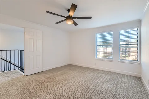 a view of a livingroom with a ceiling fan and window