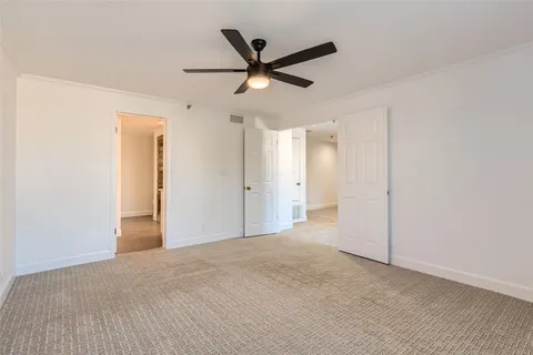 a view of a livingroom with a ceiling fan and wooden floor