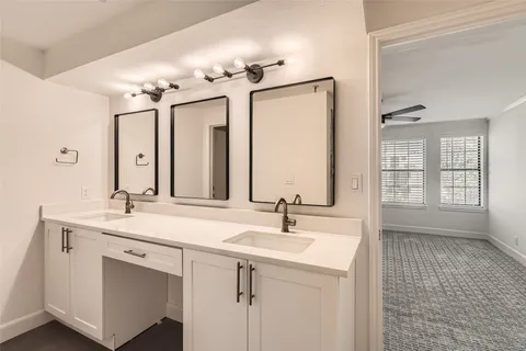 a bathroom with a sink double vanity and a mirror