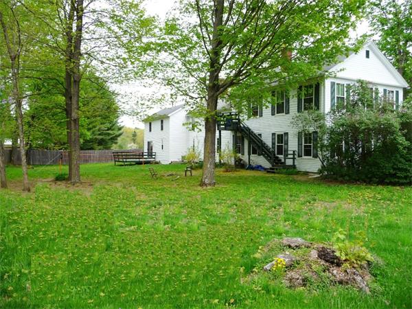 340 Bridge Road Northampton, MA 01062 - Photo 2 of 22 a view of a house with a big yard and large trees