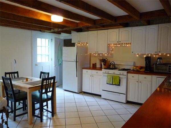 340 Bridge Road Northampton, MA 01062 - Photo 3 of 22 a kitchen with a table chairs and a refrigerator
