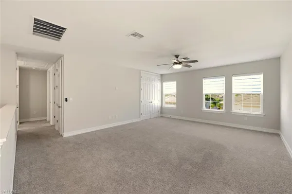a view of a chandelier fan and closet in a room