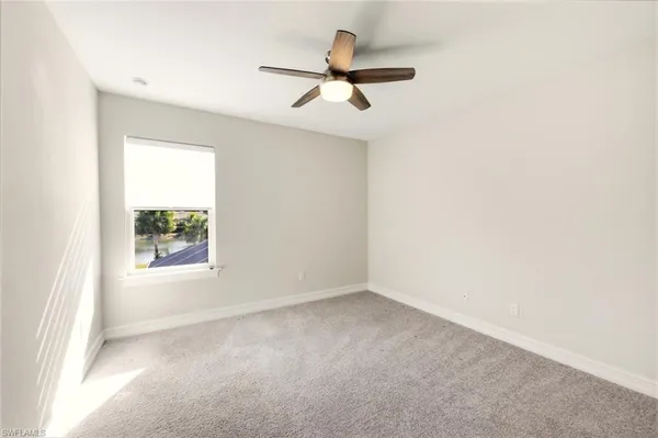 a bathroom with a granite countertop sink a mirror and a bathtub