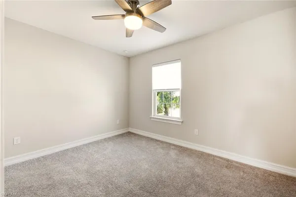 a view of a livingroom with a ceiling fan and window