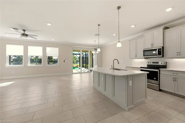 a view of kitchen with refrigerator and window
