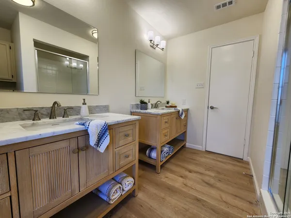 a bathroom with a double vanity sink and a mirror