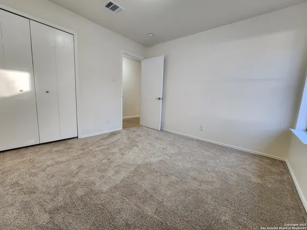 a view of an empty room and entryway
