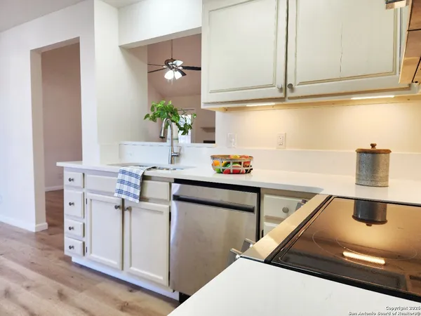 a kitchen with cabinets and window