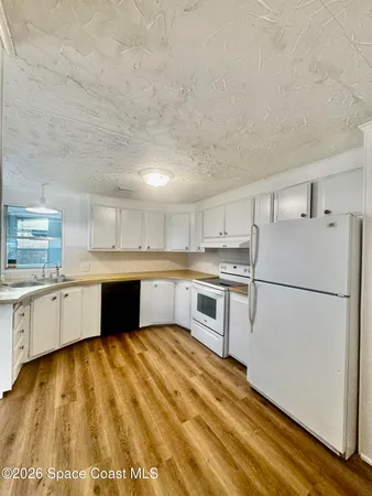 a kitchen with a refrigerator and a sink