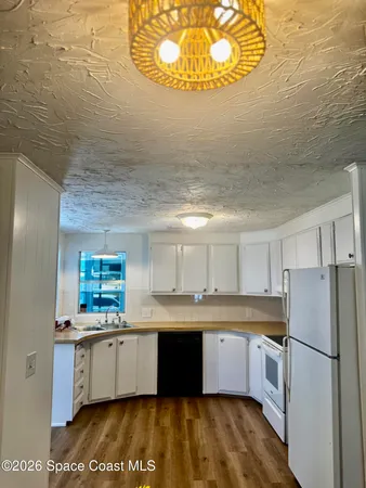 a large kitchen with a stove a refrigerator and a sink
