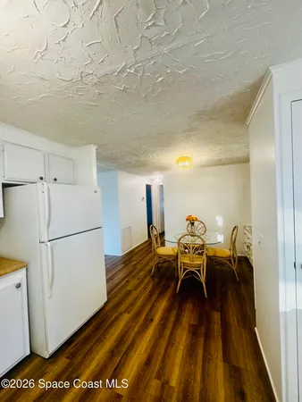 a kitchen with a refrigerator and a table