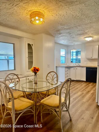 a view of a dining room with furniture and chandelier