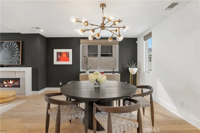 a view of a dining room with furniture and a chandelier