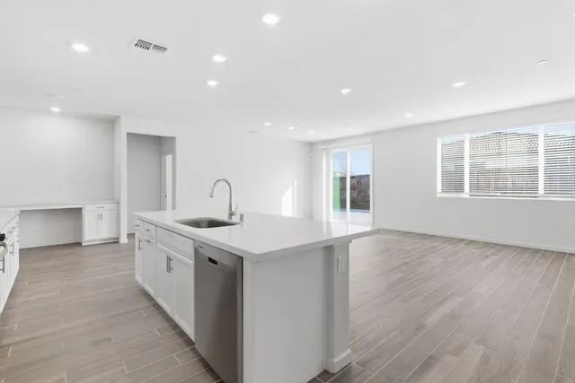 a kitchen with a sink stove and cabinets