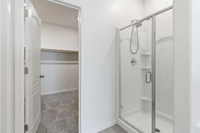 a bathroom with a glass shower door