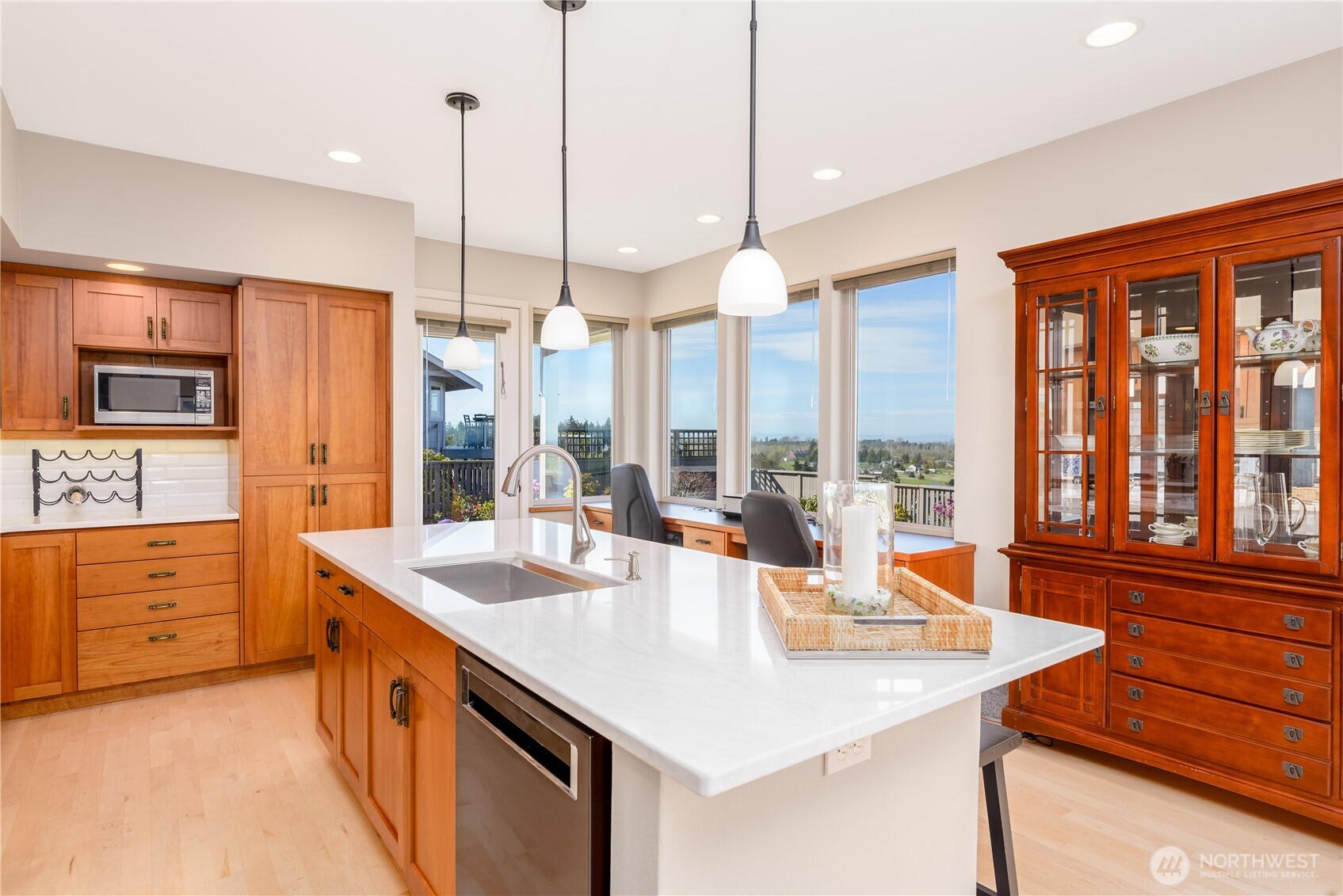 771 Brigadoon Boulevard Sequim, WA 98382 - Photo 18 of 40 a kitchen with stainless steel appliances kitchen island granite countertop a sink and a large window