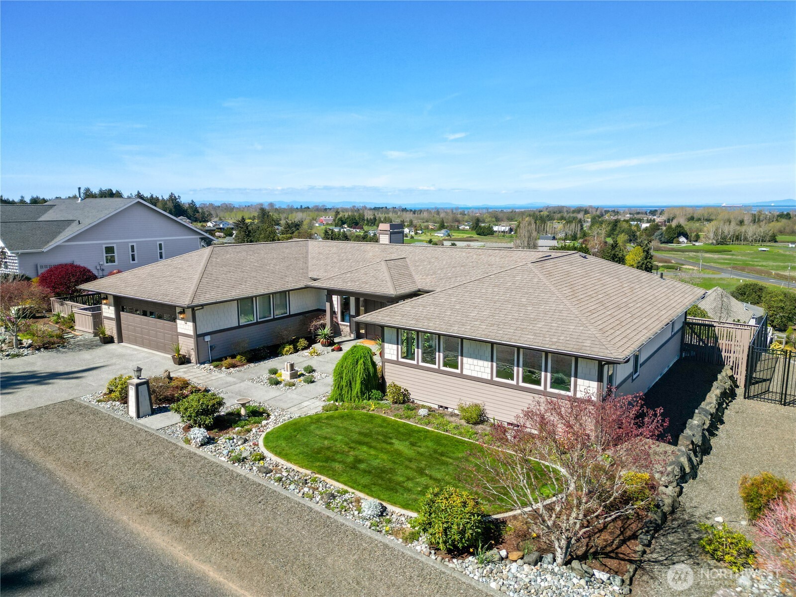 771 Brigadoon Boulevard Sequim, WA 98382 - Photo 2 of 40 an aerial view of a house with a garden and lake view