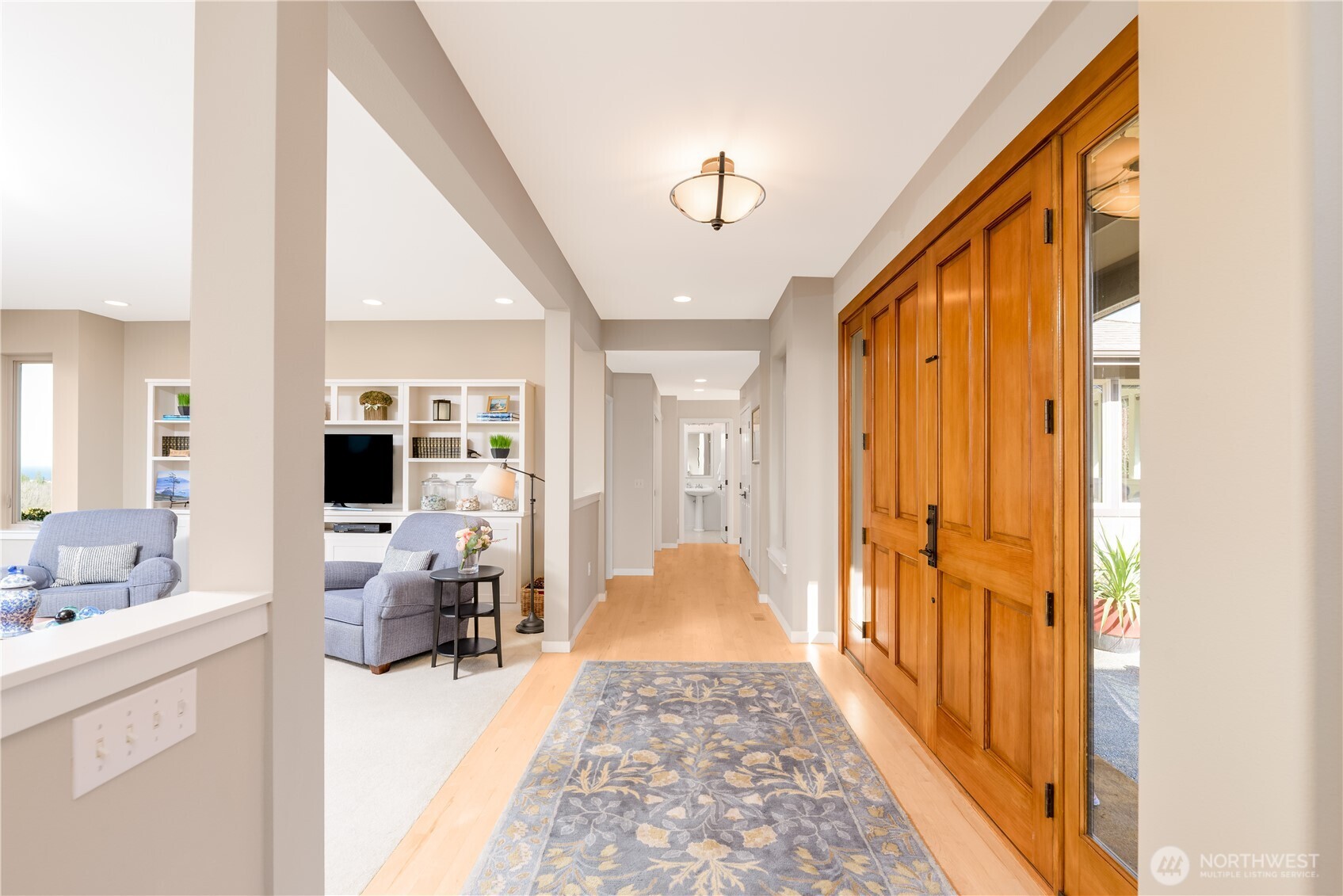 771 Brigadoon Boulevard Sequim, WA 98382 - Photo 27 of 40 a view of a hallway view with living room and wooden floor