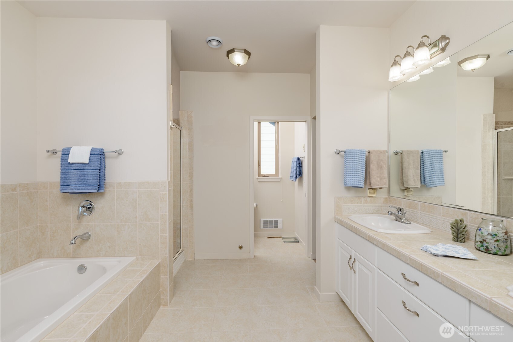 771 Brigadoon Boulevard Sequim, WA 98382 - Photo 30 of 40 a bathroom with a tub a sink double vanity and a mirror