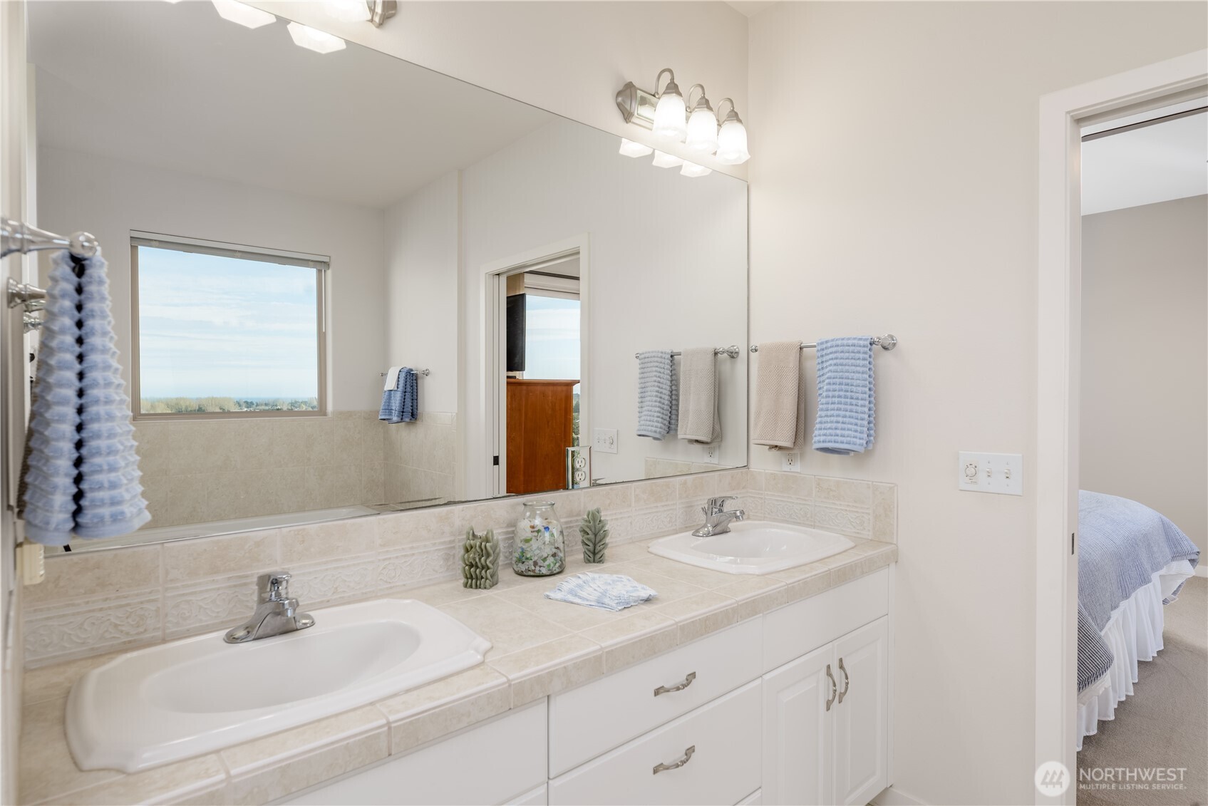 771 Brigadoon Boulevard Sequim, WA 98382 - Photo 33 of 40 a bathroom with double vanity sinks and a mirror