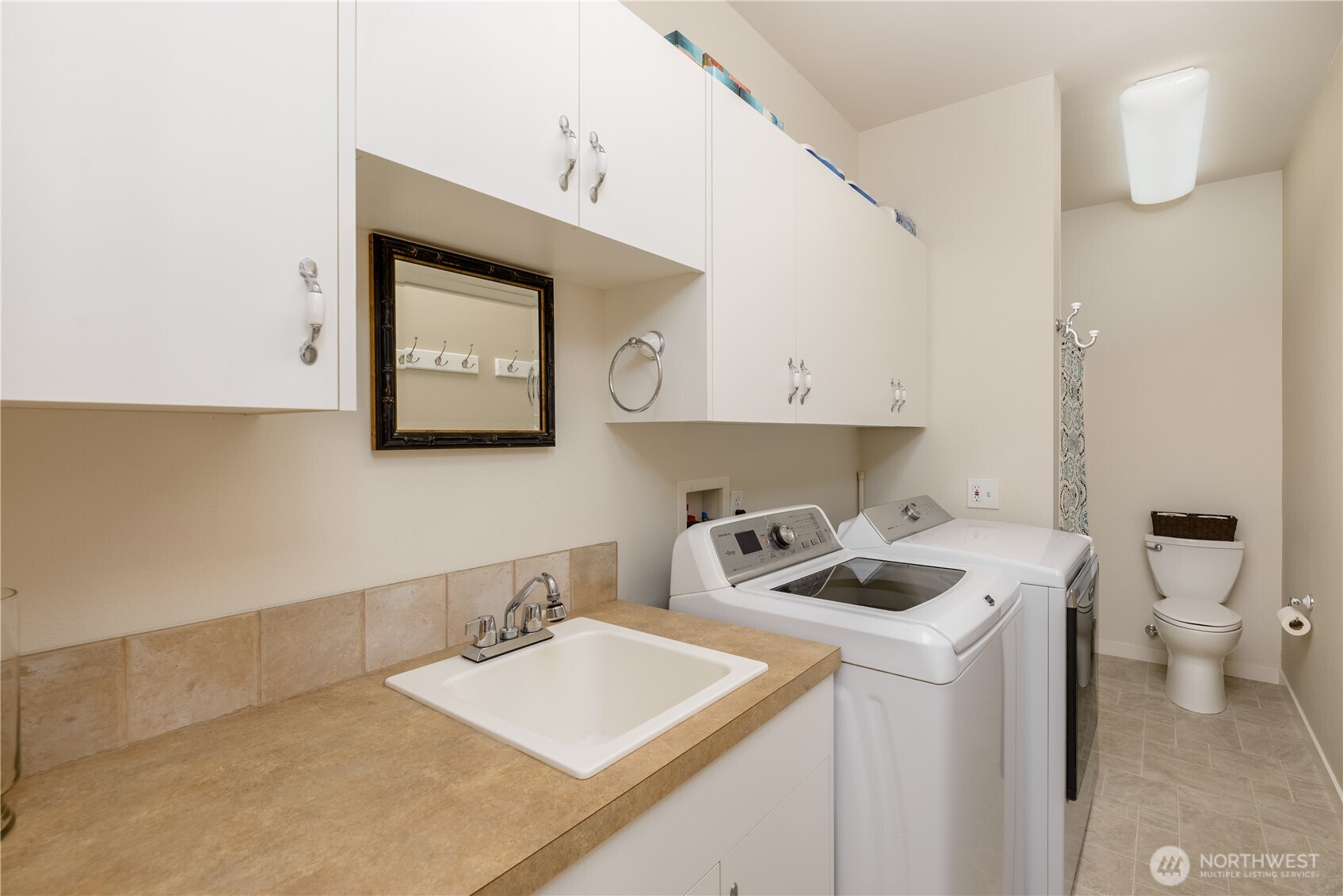 771 Brigadoon Boulevard Sequim, WA 98382 - Photo 39 of 40 a bathroom with a toilet sink and mirror
